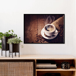 Plakat w ramie Filiżanka i ziarna kawy na drewnianym tle