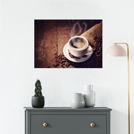 Plakat Filiżanka i ziarna kawy na drewnianym tle