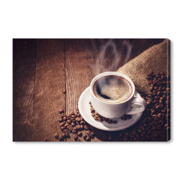 Obraz na płótnie Filiżanka i ziarna kawy na drewnianym tle