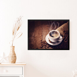 Obraz w ramie Filiżanka i ziarna kawy na drewnianym tle
