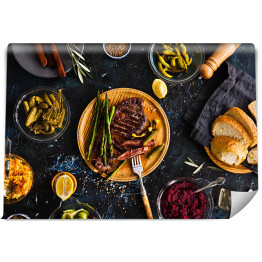 Fototapeta Stek z polędwicy wołowej z marynowanymi warzywami, ogórkiem, kapustą, dressingiem, marynowaną papryką
