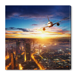 Obraz na płótnie Samolot latający nad nowoczesnym miastem