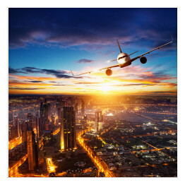 Plakat samoprzylepny Samolot latający nad nowoczesnym miastem