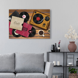 Obraz na płótnie Gramofon i rozrzucone płyty winylowe na drewnianym tle