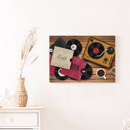Obraz na płótnie Gramofon i rozrzucone płyty winylowe na drewnianym tle