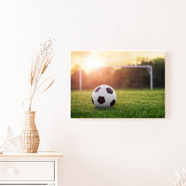 Obraz na płótnie Piłka nożna w blasku zachodzącego słońca