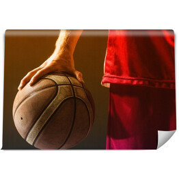Fototapeta Koszykarz w czerwonym stroju trzymający piłkę