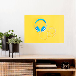Plakat Niebieskie słuchawki leżące na żółtym tle