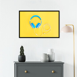 Plakat w ramie Niebieskie słuchawki leżące na żółtym tle