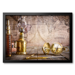 Obraz w ramie Lampa, kompas na drewnianym stole na tle mapy