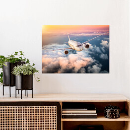 Plakat samoprzylepny Samolot nad chmurami na kolorowym niebie