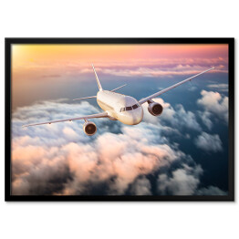 Plakat w ramie Samolot nad chmurami na kolorowym niebie