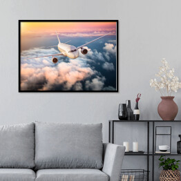 Plakat w ramie Samolot nad chmurami na kolorowym niebie
