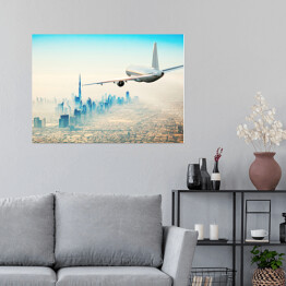 Plakat samoprzylepny Samolot latający nad nowoczesnym miastem w jasnych barwach