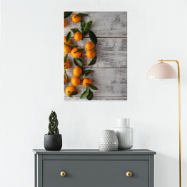 Plakat samoprzylepny Gałązka mandarynek na drewnianym stole