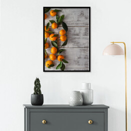 Plakat w ramie Gałązka mandarynek na drewnianym stole