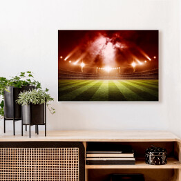Obraz na płótnie Stadion do gry w piłkę nożną oświetlony czerwonymi światłami