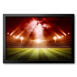 Obraz w ramie Stadion do gry w piłkę nożną oświetlony czerwonymi światłami