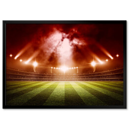 Plakat w ramie Stadion do gry w piłkę nożną oświetlony czerwonymi światłami
