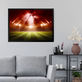 Obraz w ramie Stadion do gry w piłkę nożną oświetlony czerwonymi światłami