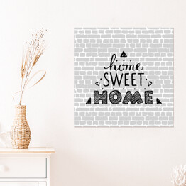 Plakat samoprzylepny "Nie ma to jak w domu" - typografia na tle imitującym szary ceglany mur 