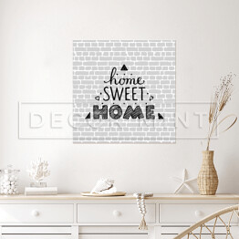 Plakat samoprzylepny "Nie ma to jak w domu" - typografia na tle imitującym szary ceglany mur 