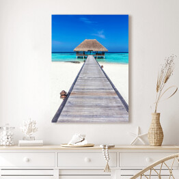 Obraz na płótnie Drewniany domek na tropikalnej plaży w słoneczny dzień