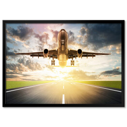 Plakat w ramie Samolot wzbijający się w powietrze o wschodzie słońca