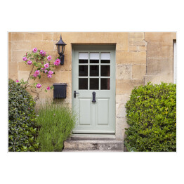 Plakat Jasne drewniane drzwi w starej tradycyjnej angielskiej chałupie w otoczeniu wspinaczki róż i lawendy