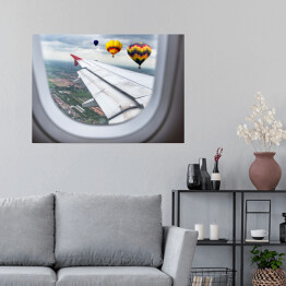 Plakat samoprzylepny Widok za okno samolotu - balony unoszące się nad chmurami