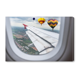 Obraz na płótnie Widok za okno samolotu - balony unoszące się nad chmurami