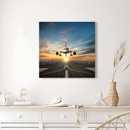 Obraz na płótnie Samolot lądujący na pasie na tle pięknego nieba