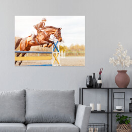 Plakat samoprzylepny Podpalany koń z dziewczyną skaczący nad przeszkodą 