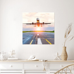 Plakat samoprzylepny Samolot startujący z lotniska o świcie