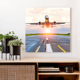 Obraz na płótnie Samolot startujący z lotniska o świcie