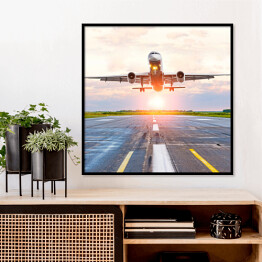 Plakat w ramie Samolot startujący z lotniska o świcie