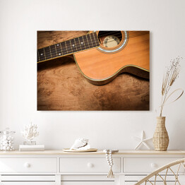 Obraz na płótnie Gitara akustyczna na tle imiującym nieociosane drewno