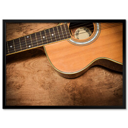 Plakat w ramie Gitara akustyczna na tle imiującym nieociosane drewno