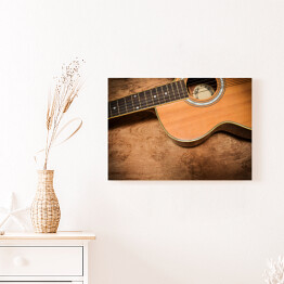 Obraz na płótnie Gitara akustyczna na tle imiującym nieociosane drewno