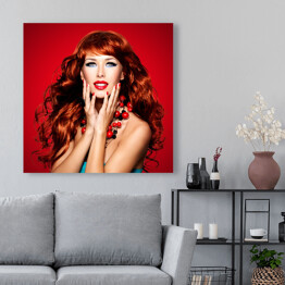Obraz na płótnie Piękna zmysłowa kobieta z długimi czerwonymi włosami na czerwonym tle