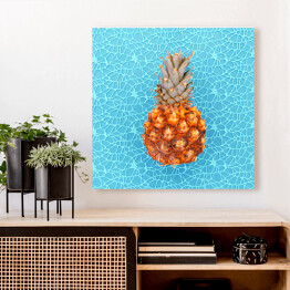 Obraz na płótnie Ananas na niebieskim wzorzystym tle