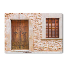 Obraz na płótnie Rustykalne drewniane drzwi do domu i ściany z kamienia