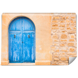 Fototapeta Drewniane niebieskie drzwi do domu na wyspach Morza Śródziemnego