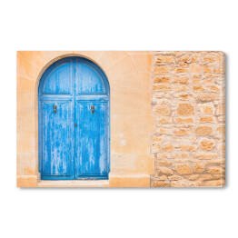Obraz na płótnie Drewniane niebieskie drzwi do domu na wyspach Morza Śródziemnego