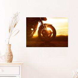 Plakat samoprzylepny Koło motocyklu na tle złocistego zachodu słońca