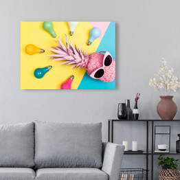 Obraz na płótnie Kolorowe żarówki wokół różowego ananasa