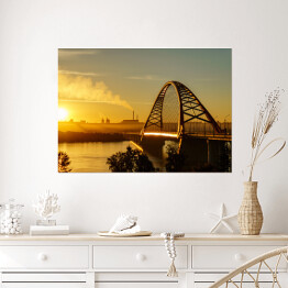 Plakat Most nad rzeką w mieście ze spektakularnym wschodem słońca w tle