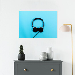 Plakat samoprzylepny Czarne słuchawki na błękitnym tle