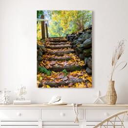 Obraz na płótnie Skaliste stopnie pokryte żółtymi liśćmi w jesiennym parku 