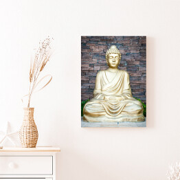 Obraz na płótnie Złoty Budda na tle ściany z cegieł
